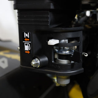 Close-up of a mechanical component with a label on a vehicle.